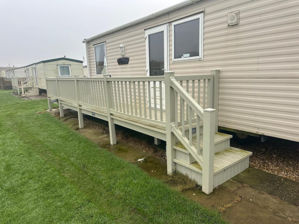 Used caravan decking with steps along the side of a static caravan