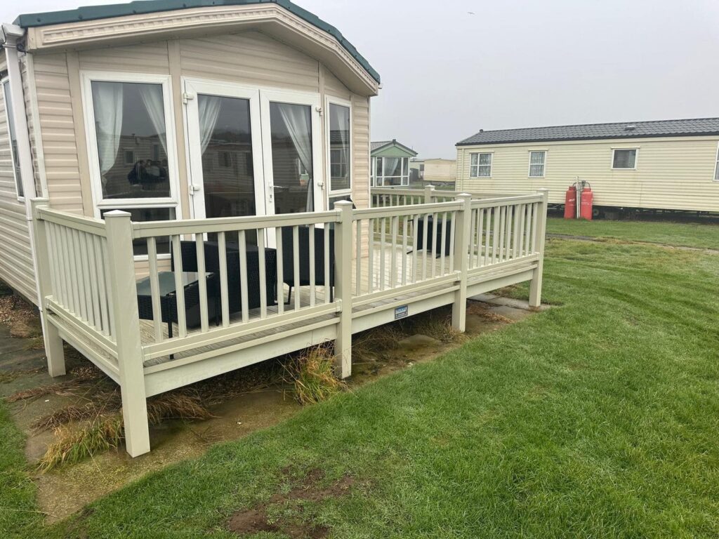 Second hand UPVC deck in front of a static caravan